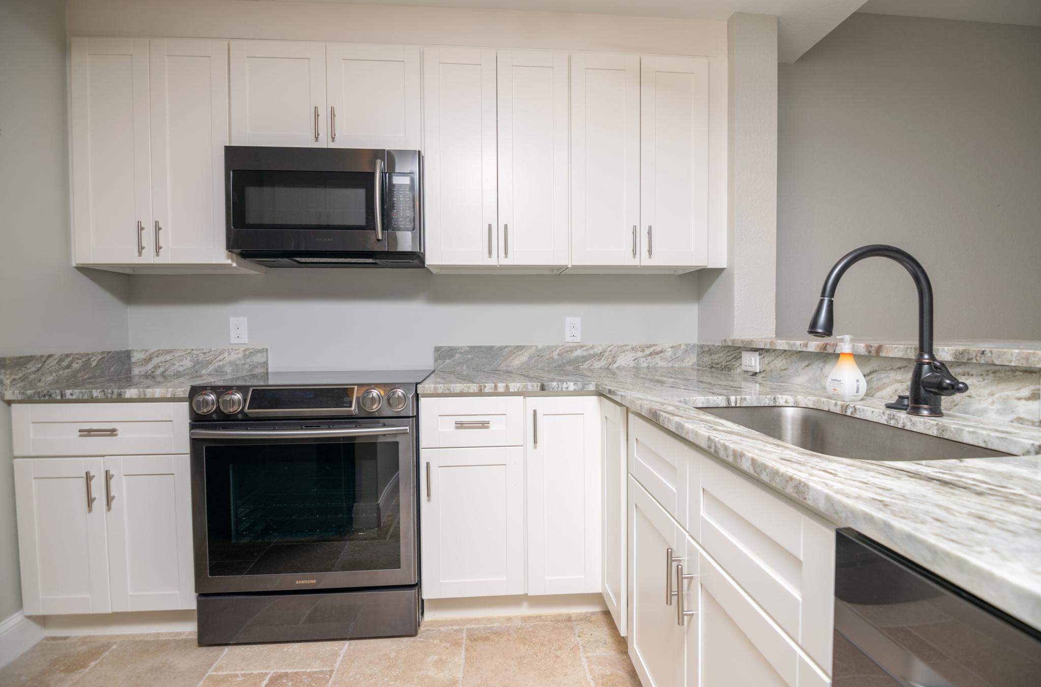 The kitchen features modern updates with a high end appliance package.
