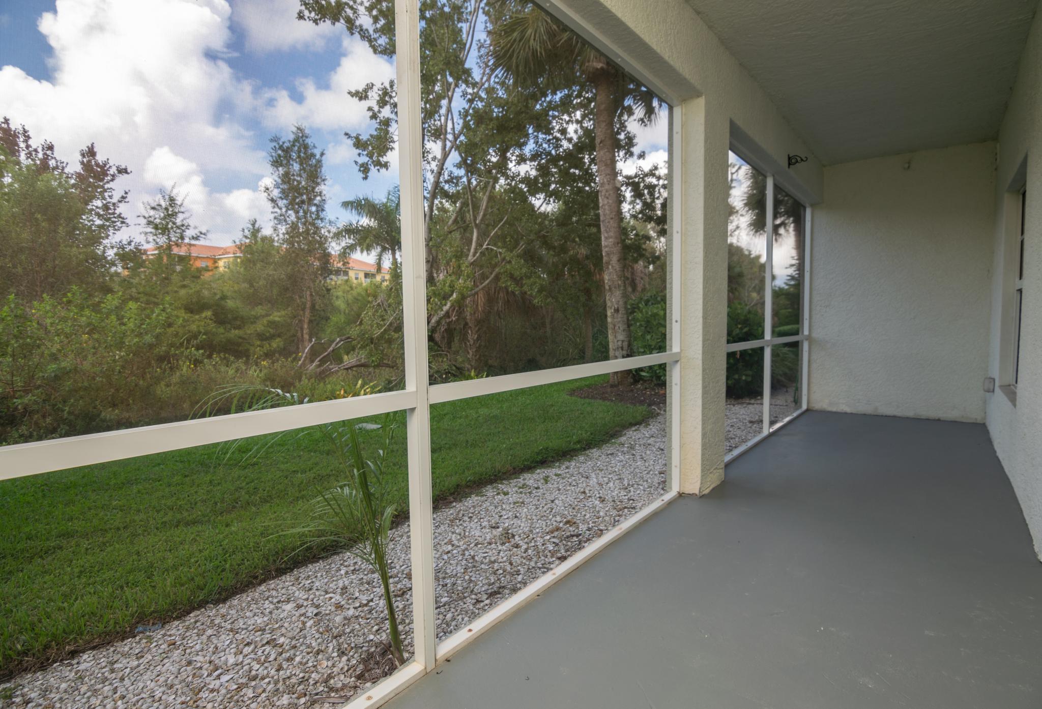 The lanai has a peaceful and secluded view of the preserve behind the building.